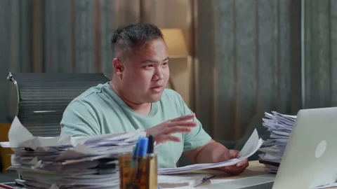 Close Up Of Fat Asian Man With Documents Explaining Work On Paper While Having Stock Footage 196113791