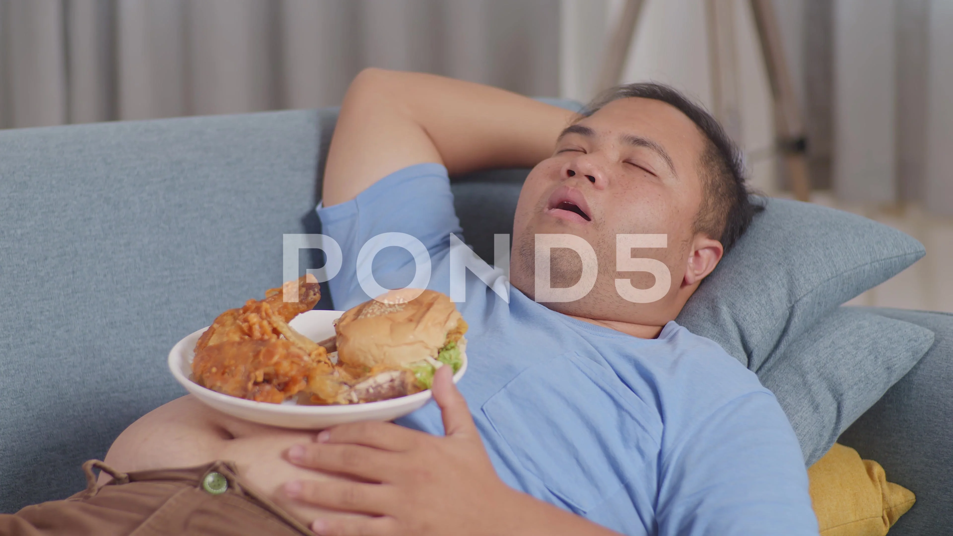 Close Up Of A Fat Asian Man Sleeping While Having French Fries With Ketchup