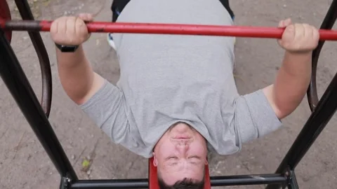 Close-up of a fat man lifting a barbell Stock Video Pond5