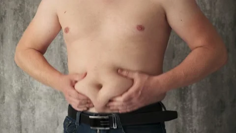 Close up fat man touch the Belly doing massage shaking. He very fat and has Stock Footage 141986550