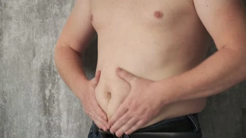 Close up fat man touch the Belly doing massage shaking. He very fat and has Stock Footage 156728605