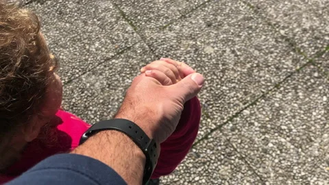 Close-up of father and son holding hands during a sunny day Stock Footage 141395331