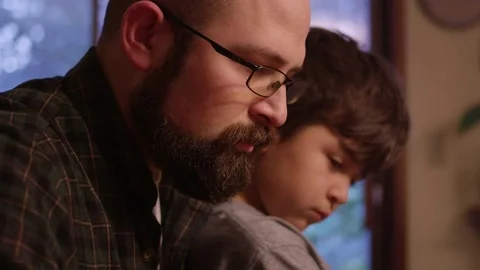 Close up of a father and son playing a board game at home Stock Footage 70716974