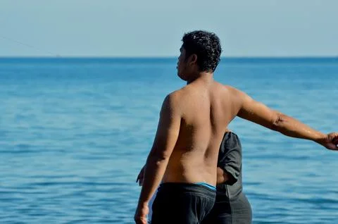Close-up of father pulling kite string with focus 写真素材