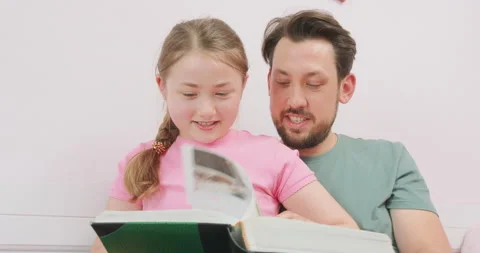 Close up of father, sitting on the sofa, and laughing teen daughter, sitting on Stock Footage 140151153