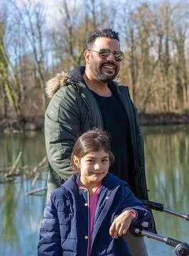 Close-up of father with stroller and two children walking along the Aare rive Stock-Fotos
