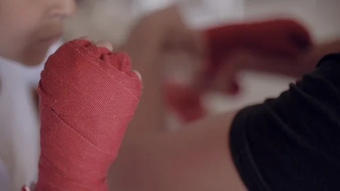 Close-up of fathers hands putting on red straps for his son, getting ready for Stock Footage 111550007