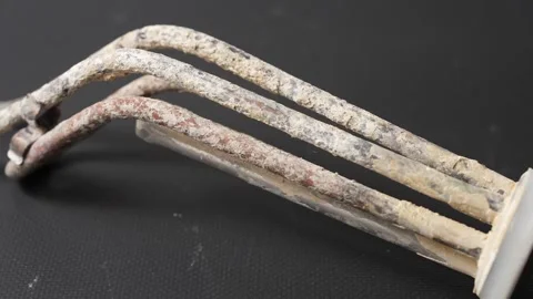Close-up of a faulty heating element covered with limescale Stock Footage 325685882
