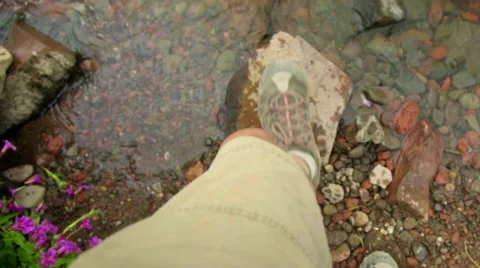 Close up of feet crossing stream Stock Footage 59576047