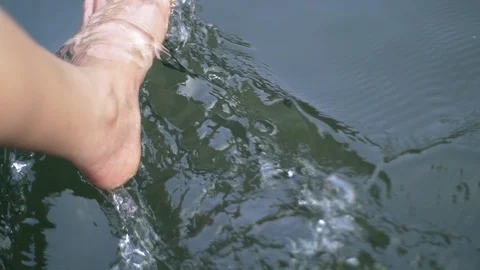 Close up of feet dip into river in the forrest Stock Footage 106176618