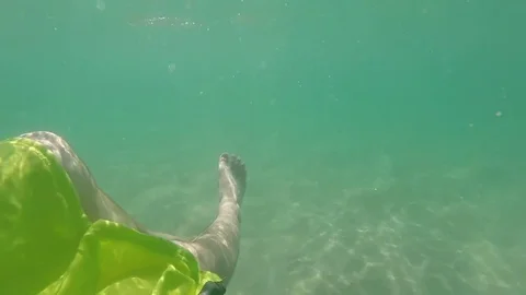Close up of feet floating in ocean man relaxing in clear blue tropical water on Stock Footage 85291401