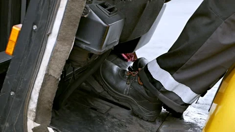 Close-up of the feet of a forklift driver.The loader driver at work Stock Footage 119656356
