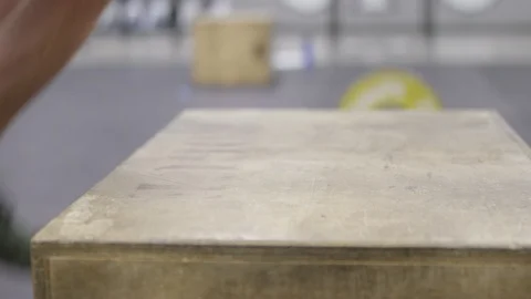 Close up of feet jumping on top of a box in Crossfit gym Stock Footage 113725547