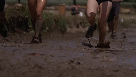 Close up feet running through mud in race Video stock 92562619
