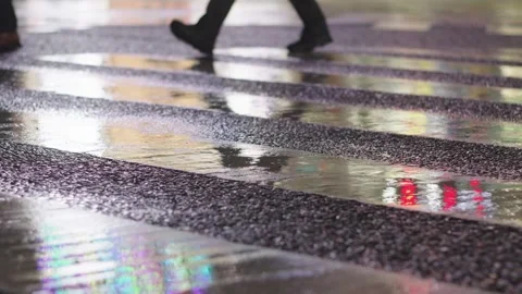 Close-up of a feet stepping into a muddy puddle at night Stock Footage 278417261