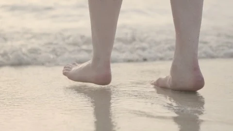 Close up of feet walking into an ocean Stock Footage 108520163