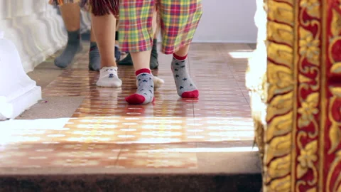 Close-Up of Feet Walking Through a Quiet Buddhist Temple Courtyard Stock-Footage 333706766