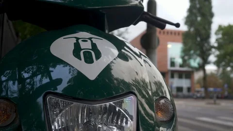 A close up of the Felyx logo on a green electric scooter standing in Stock Footage 94844756