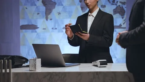 Close-up of a female administrator is working. The man shows his passport Video stock 233994658