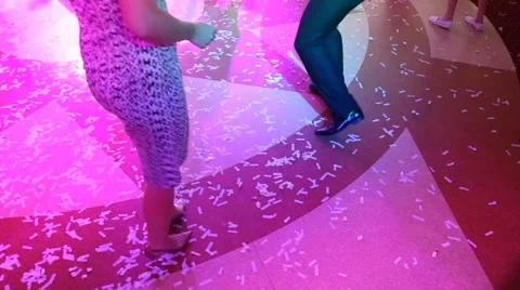 Close up of female and male legs of young couple dancing at night club Stock Footage