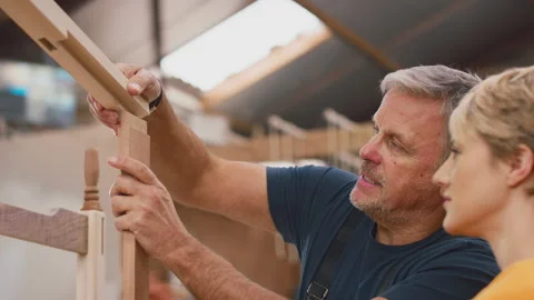 Close Up Of Female Apprentice Learning Skills From Mature Male Carpenter In Stock Footage 242244296