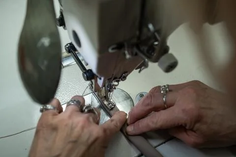 Close-Up of Female Artisan Skillfully Operating a Sewing Machine to Create .. Stock Photos