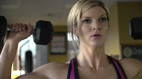 Close up of female athlete lifting weights overhead Stock Footage 33689743