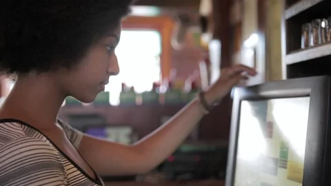 Close up female bartender using computer POS in bar 스톡 동영상 220078802