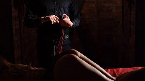 Close-up of female buttocks during preliminary games. A man spanks his mistress Stockbeeldmateriaal 119978067