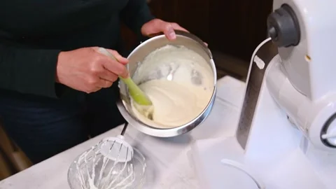 Close-up of female chef confectioner using silicone spatula mixing cream cheese  Stock Footage 194729650