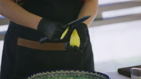 Close Up of Female Chef Hands in Gloves Slicing Yellow Carrot for Pilaf Stock Footage 332987474