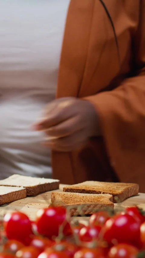 Close up of female chef using cream cheese spread on a bread slice Stock Footage 333616776
