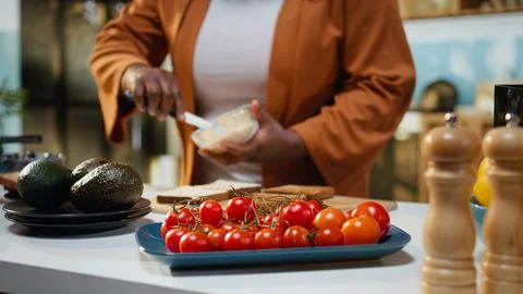 Close up of female chef using cream cheese spread on a bread slice Stock Photos
