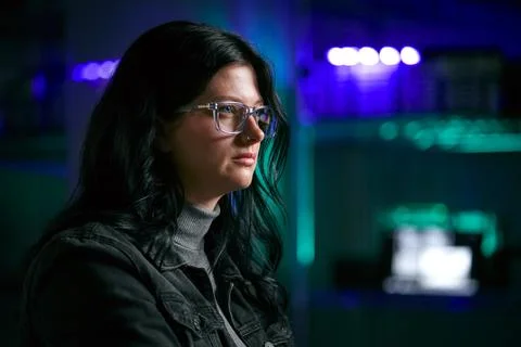 Close Up Of Female Computer Hacker Sitting In Front Of Screens Breaching Cyber Stock Photos