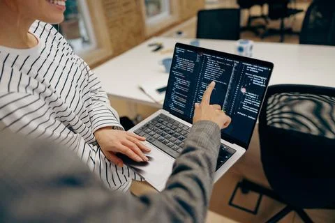 Close up of female computer programmers is coding at laptop while standing in 스톡 사진