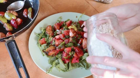 Close-up of female cook serving exotic sweet salad with vegetables and fruits Stock Footage 100590632