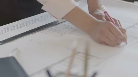 Close up female designer hands working with blueprints Stock Footage