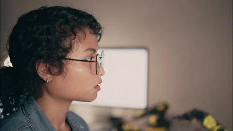 Close-up of female developer wearing glasses coding at night. Stock Footage 319001087