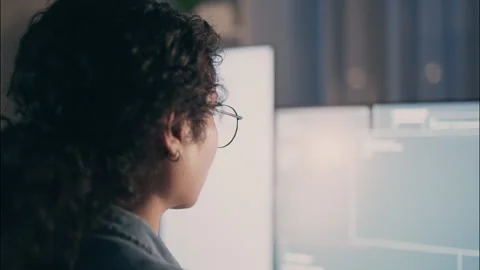 Close-up of female developer wearing glasses coding at night. Stock Footage 319001122