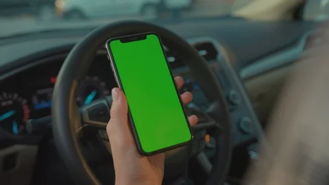 Close-up of female driver using vertical smartphone online navigation app in Stock Footage 117548527