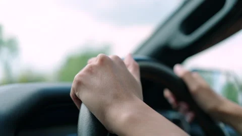 Close-up of female driver's hands on steering wheel Stock Footage 345325127