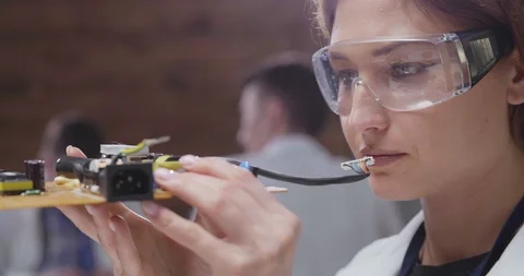 Close up of female electronics engineer examining motherboard Stock-Footage 97519682