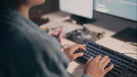 Close-Up of Female Engineer Typing Code Late at Night in Tech Workspace. Stock Footage 307586522