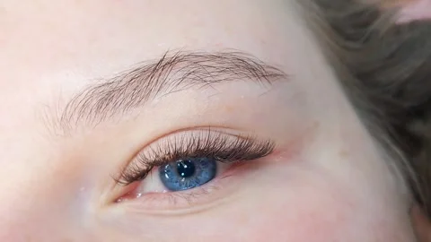 Close up of female eye with eyelash extensions ,eyelash extension procedure. Stock Footage 318965939