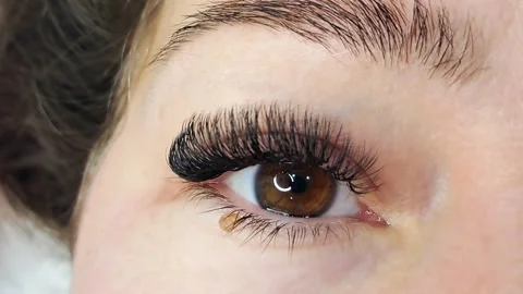 .Close up of female eye with eyelash extensions ,eyelash extension procedure. Stock Footage 324857820