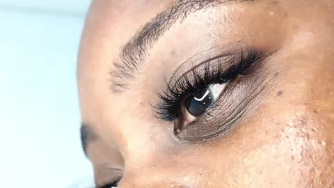 Close up of female eye with eyelash extensions in beauty salon Stock Footage 329012100