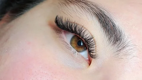 Close up of female eye with eyelash extensions in beauty salon Stock Footage 329012111