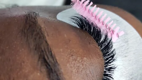 Close up of female eye with eyelash extensions in beauty salon Stock Footage 329012130