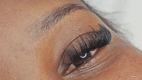 Close up of female eye with eyelash extensions in beauty salon Stock Footage 329012135