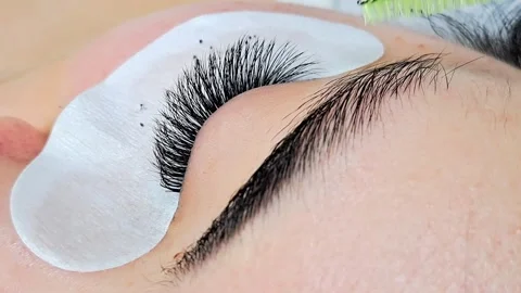 Close up of female eye with eyelash extensions in beauty salon Stock Footage 329012143